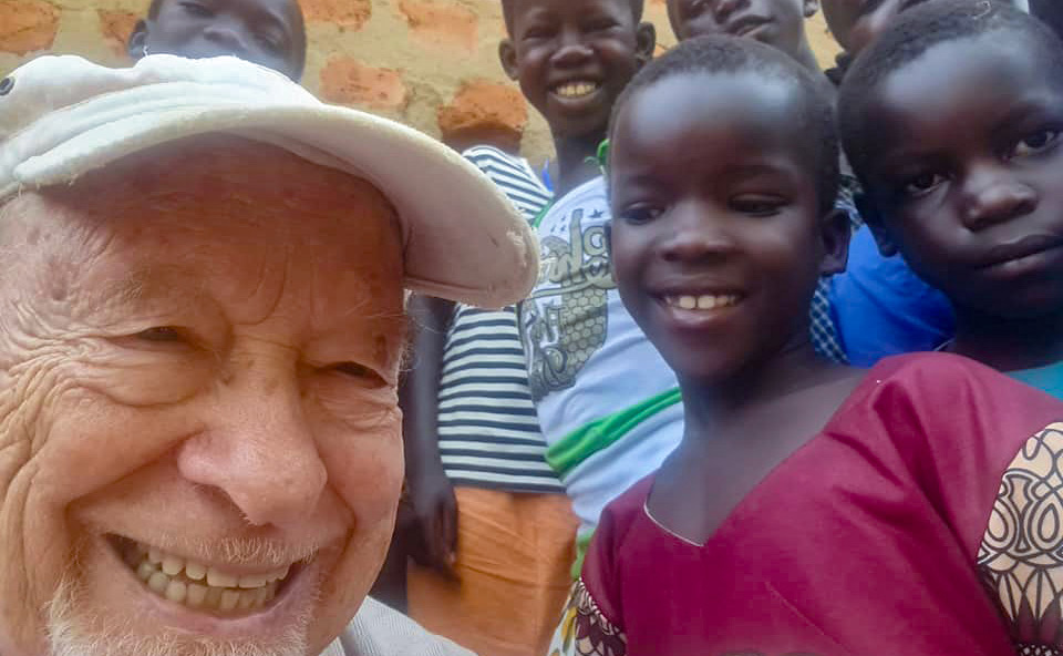 Fr Alberto Anichini takes a selfie with young children from his mission.