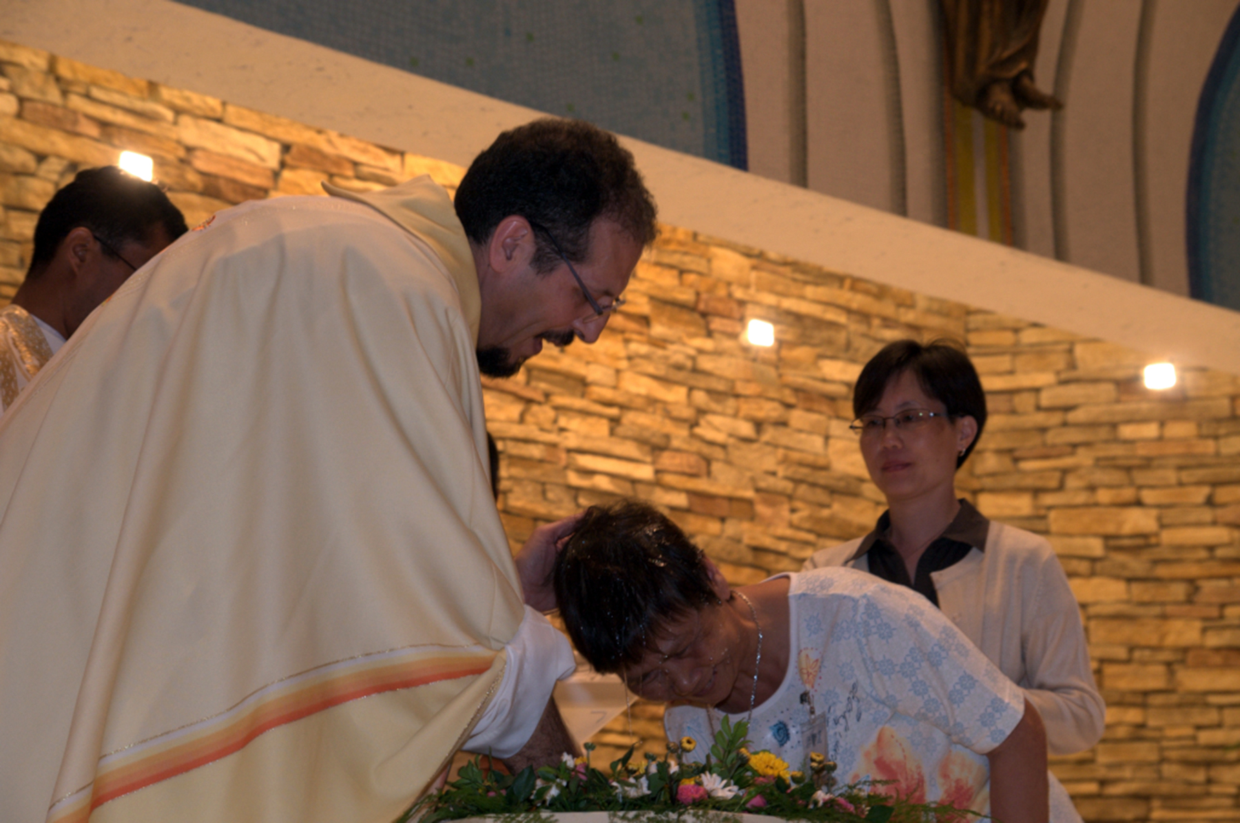 A comboni missionaries baptizes a womn in Macau