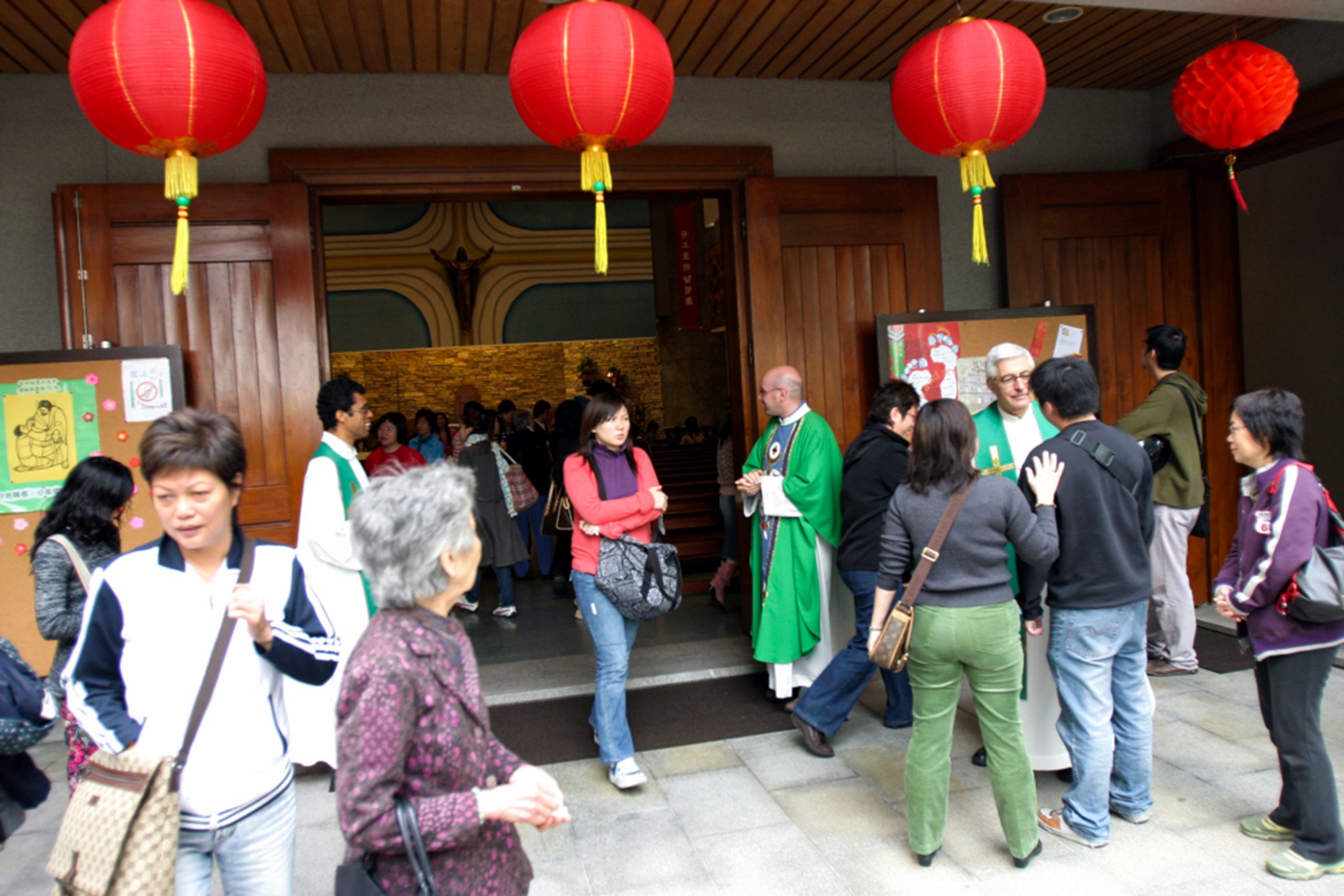 A priests greets visitors to Mass at a church in Macau China