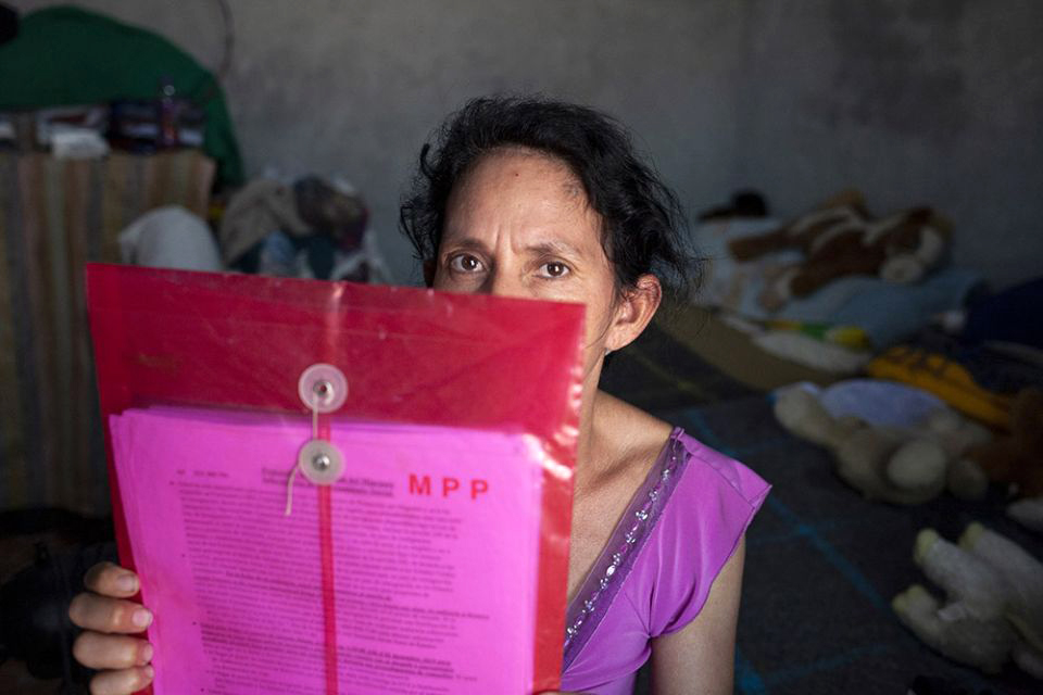 Maria Piñeda Serrano of Honduras shows the file that holds her Migrant Protection Protocols paperwork at the El Buen Samaritano shelter in Nuevo Laredo, Mexico.