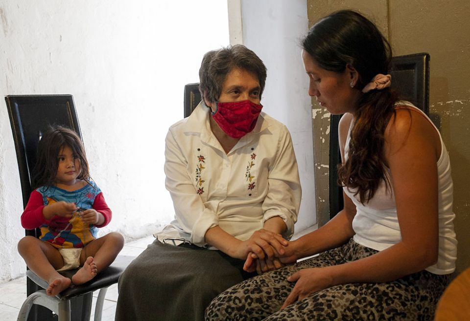 Sr. Mercedes Castillo, second from left, comforts Noelia Marlene Vásquez of Honduras while her daughter, Lindsey Gimena Rodas, 2, sits nearby at the El Buen Samaritano shelter.