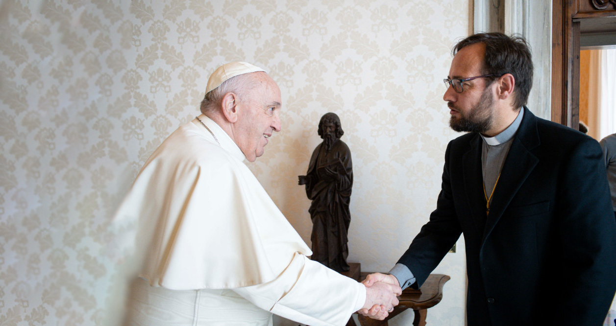 Bishop Carlassare shakes hands with Pope Francis