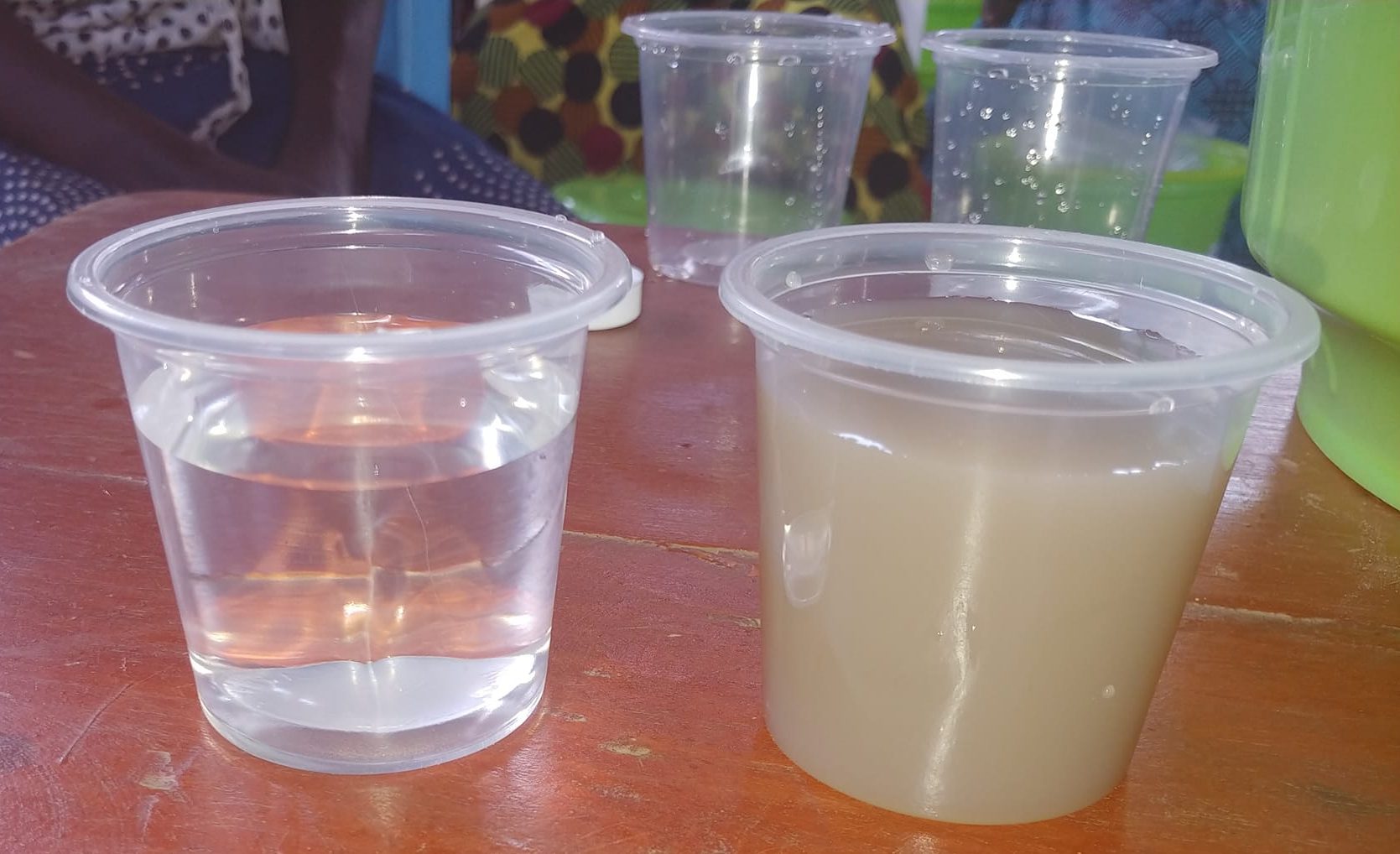 a cup of clear, clean, recently filtered water is next to a cup or brown, unfiltered water demonstrating the difference a SawyerOne filter can make