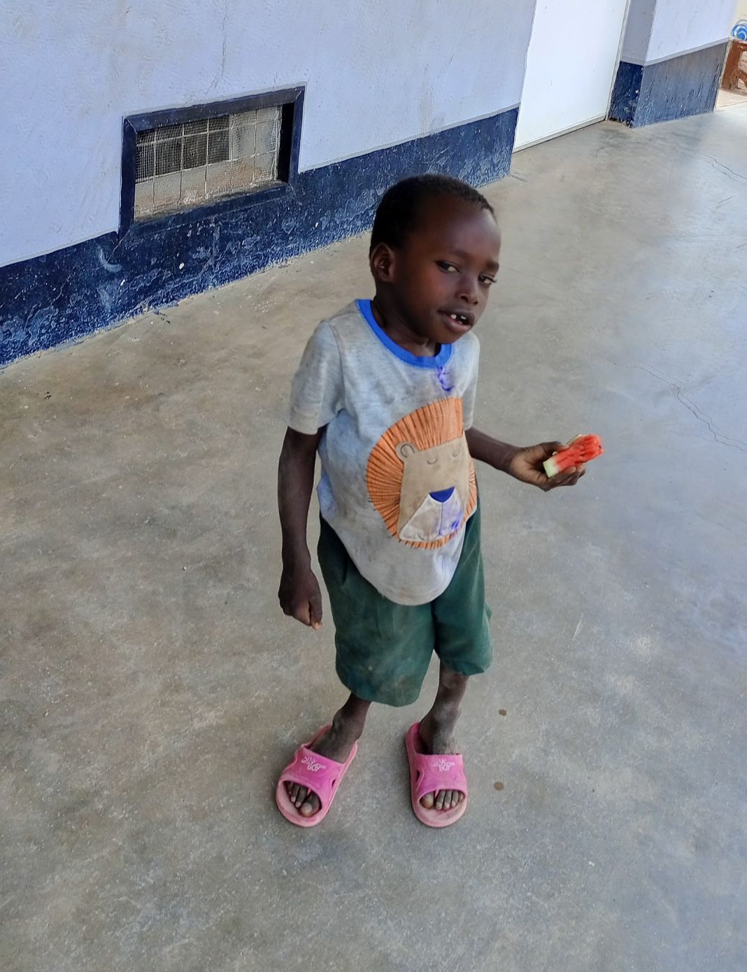 A young resident at St John Paul II home in Lodwar eats watermelon