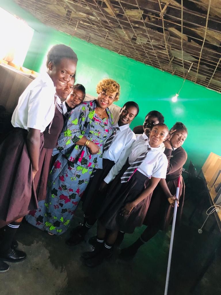 Students stand in the new computer lab support by small mission projects