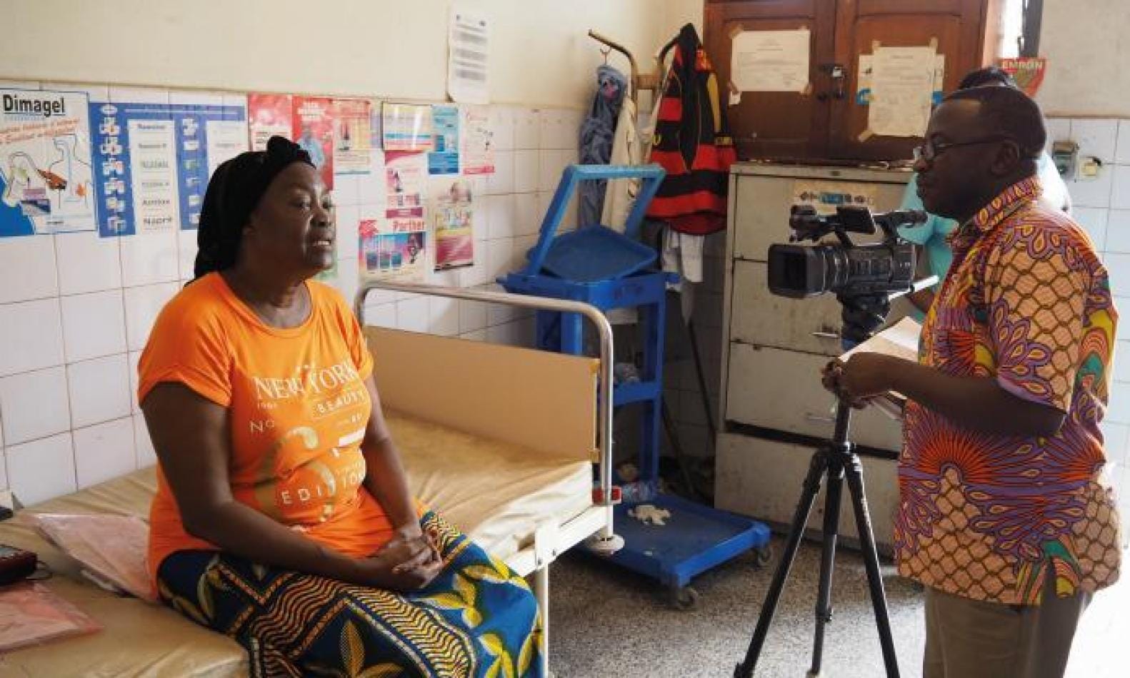 Brother Lwanga interviews a woman at a hospital