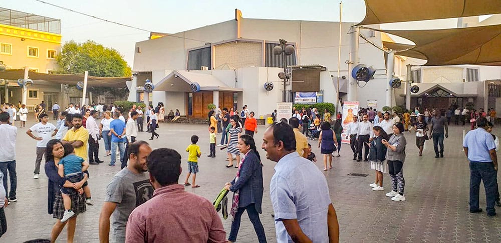 People gather outside St. Mary's Church in Dubai, United Arab Emirates, in 2018.