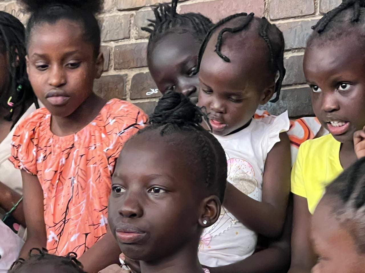 Sudanese children sit together.