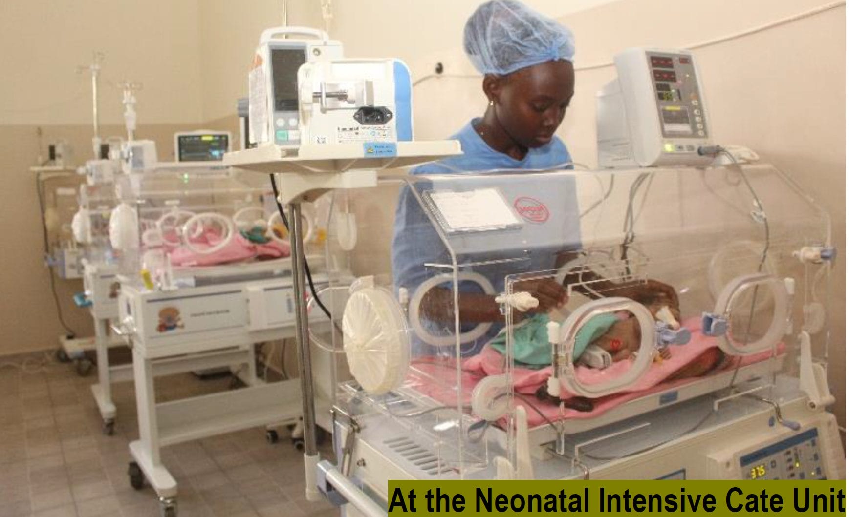 A black nurse cares for a baby in a neonatal incubator