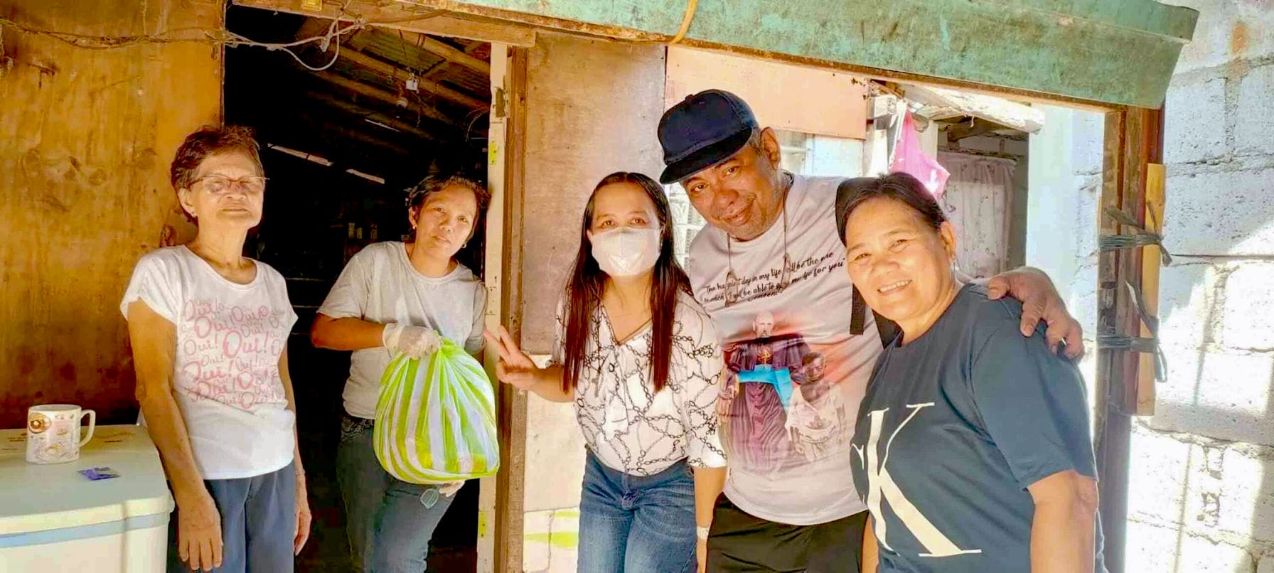 Bro Mario Castro Bro Mario stands with his arms around two parishioners from the Philippines.