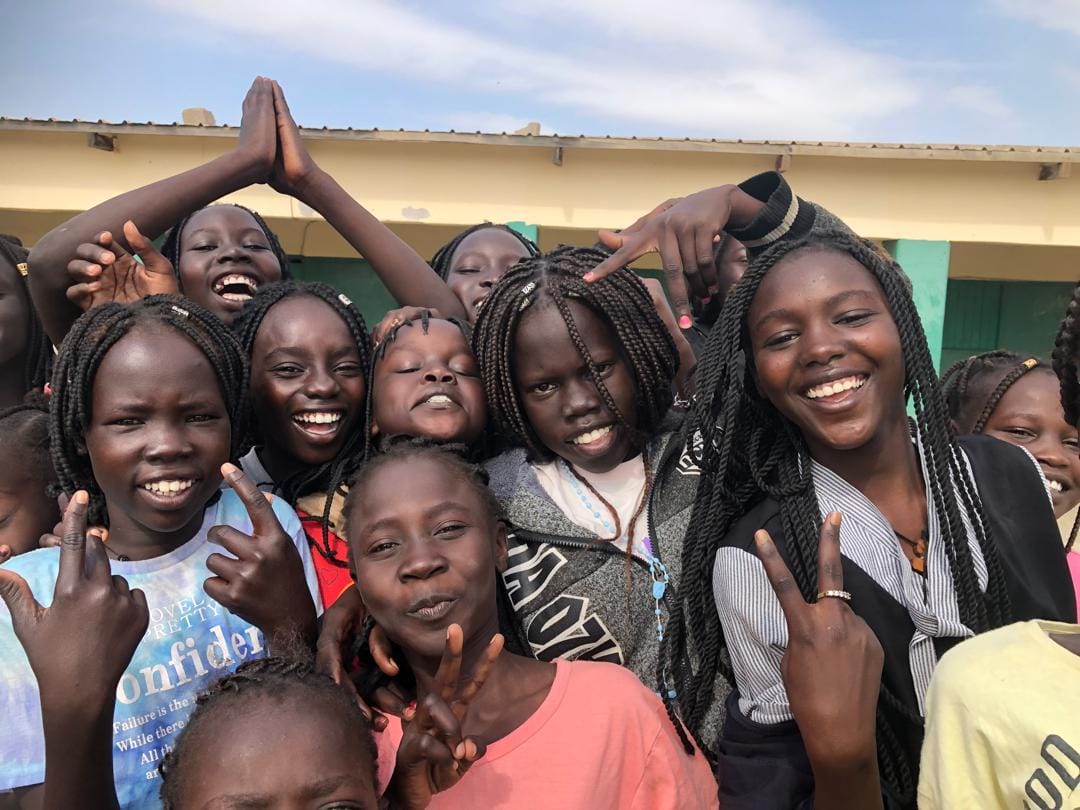 Young women from Sudan smile for the camera