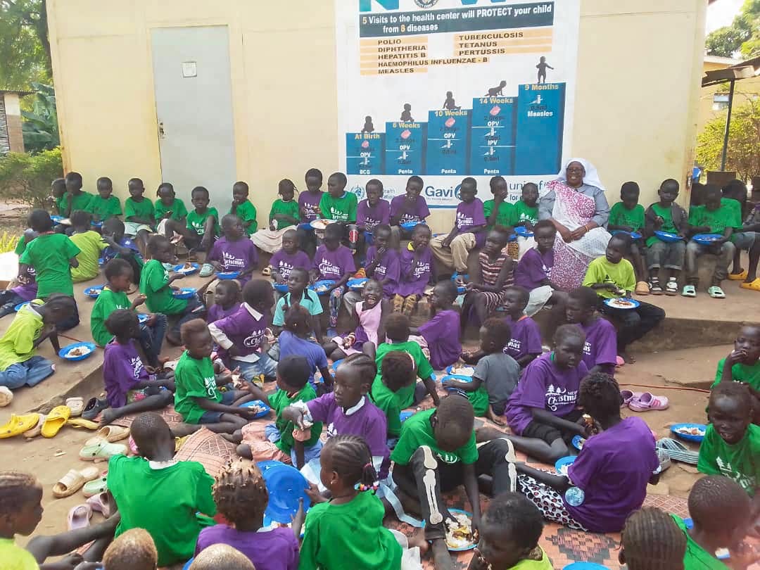 Juba Orphans African Children gather outside with Sr Rosemary. They are all wearing new shirts she bought them for Christmas.