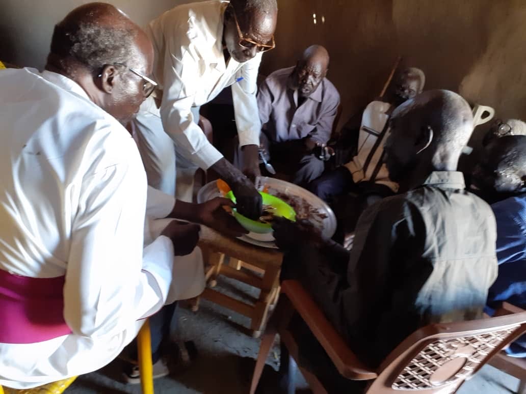 Bishop Stephen Majwok of Malakal helps feed the blind and elderly in the camp for displaced persons